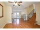 Bright and airy living room features gleaming hardwood floors, a fireplace, and stairway to upper floor at 5711 W 92Nd Ave # 30, Westminster, CO 80031