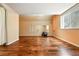 Spacious basement with wood floors, a mirror, and natural light from the window at 4944 W 107Th Loop, Westminster, CO 80031