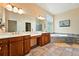 Relaxing bathroom featuring a jacuzzi tub, double sinks with white countertops, and vanity with storage at 4944 W 107Th Loop, Westminster, CO 80031