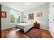 Light-filled bedroom with hardwood floors, large windows, and decorative rugs adding warmth and character at 4944 W 107Th Loop, Westminster, CO 80031