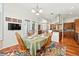 Bright dining area featuring hardwood floors, a stylish rug, and kitchen access at 4944 W 107Th Loop, Westminster, CO 80031