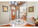 Spacious foyer showcasing a decorative tile floor, a wooden front door, and a view of the staircase leading to upper level at 4944 W 107Th Loop, Westminster, CO 80031