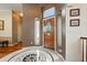 Elegant foyer with a decorative tile floor, a wooden front door, and arched doorways enhancing the entrance at 4944 W 107Th Loop, Westminster, CO 80031