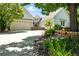 Well-maintained home featuring a circular entryway, stone accents, and a beautifully landscaped front yard with flowers at 4944 W 107Th Loop, Westminster, CO 80031