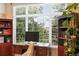 Bright home office with large windows and scenic views, featuring custom wooden shelving and furniture at 4944 W 107Th Loop, Westminster, CO 80031