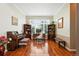 Inviting home office with piano, custom wooden shelves, large windows, and hardwood floors at 4944 W 107Th Loop, Westminster, CO 80031