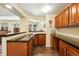 Open concept kitchen with dark countertops, wood cabinets and stainless steel appliances at 4944 W 107Th Loop, Westminster, CO 80031