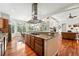 Open-concept kitchen featuring granite countertops, stainless hood and access to dining and living rooms at 4944 W 107Th Loop, Westminster, CO 80031