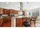 Bright kitchen featuring wooden cabinets, stainless steel appliances, granite countertops and island with barstool seating at 4944 W 107Th Loop, Westminster, CO 80031