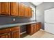 Practical laundry room with ample counter space, built-in cabinets, sink, and tiled flooring, offering great storage at 4944 W 107Th Loop, Westminster, CO 80031