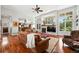 Bright living room with hardwood floors, large windows, a fireplace, and an open floor plan leading to the kitchen at 4944 W 107Th Loop, Westminster, CO 80031