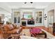 Spacious living room featuring hardwood floors, large windows, a modern fireplace, and a cozy seating area at 4944 W 107Th Loop, Westminster, CO 80031