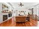 Well-lit living room with hardwood floors, a fireplace, and an open layout perfect for Gathering gatherings and entertaining guests at 4944 W 107Th Loop, Westminster, CO 80031