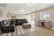 Large basement area with a black leather sofa, entertainment center, and walkout access at 444 Pasada Way, Monument, CO 80132