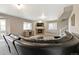 Finished basement area with a stone fireplace, entertainment center, and dark leather sofa at 444 Pasada Way, Monument, CO 80132