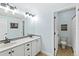 The bathroom has a double sink vanity and opens to the toilet with shower and tub, offering convenience at 444 Pasada Way, Monument, CO 80132