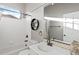 Clean bathroom featuring a tub, toilet, vanity with storage, and decorative mirror at 444 Pasada Way, Monument, CO 80132