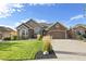 Charming single-Gathering home with manicured lawn, stone accents, attached garage, and inviting curb appeal at 444 Pasada Way, Monument, CO 80132