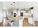An open kitchen featuring stainless steel appliances and a center island with bar seating at 444 Pasada Way, Monument, CO 80132