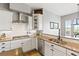 Kitchen featuring stainless steel appliances, granite countertops, and white cabinetry at 444 Pasada Way, Monument, CO 80132