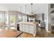Open-concept kitchen island with a bar, connecting to the cozy living room and outdoor access at 444 Pasada Way, Monument, CO 80132