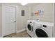 This laundry room has a washer and dryer, tile floors, and a door to the side, offering functionality at 444 Pasada Way, Monument, CO 80132