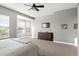 Bright main bedroom with large windows, a ceiling fan, and ample space for relaxation at 444 Pasada Way, Monument, CO 80132