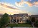 Beautiful two-story home features a spacious deck, lush green lawn, and meticulously landscaped backyard at 444 Pasada Way, Monument, CO 80132