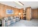 Finished basement with paneled walls, large window, and comfortable seating at 1950 S Helena St # D, Aurora, CO 80013