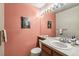 Half-bath features ample lighting and a pedestal sink at 1950 S Helena St # D, Aurora, CO 80013