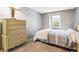 Cozy bedroom features a large dresser and a sunny window at 1950 S Helena St # D, Aurora, CO 80013