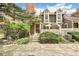 Inviting townhome with a brick facade, white picket fence, and lush landscaping at 1950 S Helena St # D, Aurora, CO 80013