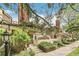 Charming townhome exterior featuring a brick chimney, landscaped garden, and inviting front entrance at 1950 S Helena St # D, Aurora, CO 80013