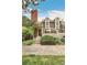 Inviting townhome front entrance with manicured landscaping, a brick chimney, and a cozy patio area at 1950 S Helena St # D, Aurora, CO 80013