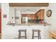 Well-equipped kitchen with a breakfast bar, wooden cabinets, and stainless steel appliances at 1950 S Helena St # D, Aurora, CO 80013