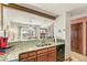 Updated kitchen features granite countertops, wood cabinets, and a breakfast bar overlooking the living area at 1950 S Helena St # D, Aurora, CO 80013