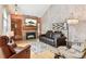 Cozy living room featuring a brick fireplace, hardwood floors, and a comfortable seating area at 1950 S Helena St # D, Aurora, CO 80013