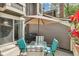 Relaxing patio with umbrella, outdoor seating, and view of surrounding yard at 1950 S Helena St # D, Aurora, CO 80013