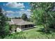 Spacious backyard with a screened-in porch, patio area, and lush green lawn at 5350 Yellowstone St, Bow Mar, CO 80123