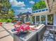 Outdoor seating area with plush furniture and beautiful flower arrangements under a pergola at 5350 Yellowstone St, Bow Mar, CO 80123