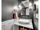Stylish powder room featuring a marble countertop, vessel sink, elegant sconces, and modern fixtures at 5350 Yellowstone St, Bow Mar, CO 80123