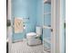 Clean bathroom featuring a white toilet, towel rack, black and white tiled floor, and storage shelves at 5350 Yellowstone St, Bow Mar, CO 80123
