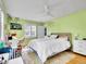 Bright bedroom featuring hardwood floors, a ceiling fan, a modern bed, and a cozy workspace by the window at 5350 Yellowstone St, Bow Mar, CO 80123