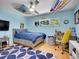 Comfortable bedroom with a bed, ceiling fan, window views, and a cozy, inviting atmosphere with playful decor at 5350 Yellowstone St, Bow Mar, CO 80123