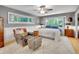 Comfortable bedroom featuring hardwood floors, natural light, and ceiling fan at 5350 Yellowstone St, Bow Mar, CO 80123
