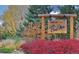 Welcome to Bow Mar: A charming neighborhood entrance with colorful foliage and a wooden sign at 5350 Yellowstone St, Bow Mar, CO 80123