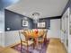 Formal dining room with hardwood floors, wainscoting, chandelier, and seating for six at 5350 Yellowstone St, Bow Mar, CO 80123