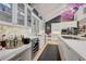 Modern eat-in kitchen with marble countertops, stainless steel appliances, and custom white cabinets at 5350 Yellowstone St, Bow Mar, CO 80123