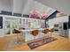 Spacious eat-in kitchen featuring a large center island, stainless steel appliances and unique chandeliers at 5350 Yellowstone St, Bow Mar, CO 80123