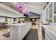 Open floor plan kitchen with light hardwood flooring, marble countertops, island, and breakfast bar at 5350 Yellowstone St, Bow Mar, CO 80123
